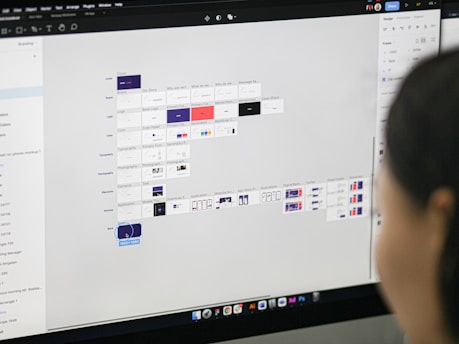 a woman is looking at a computer screen