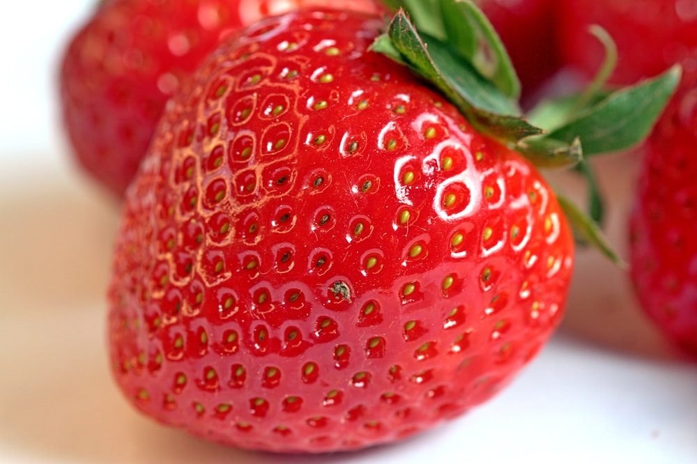 a close up of a group of strawberries