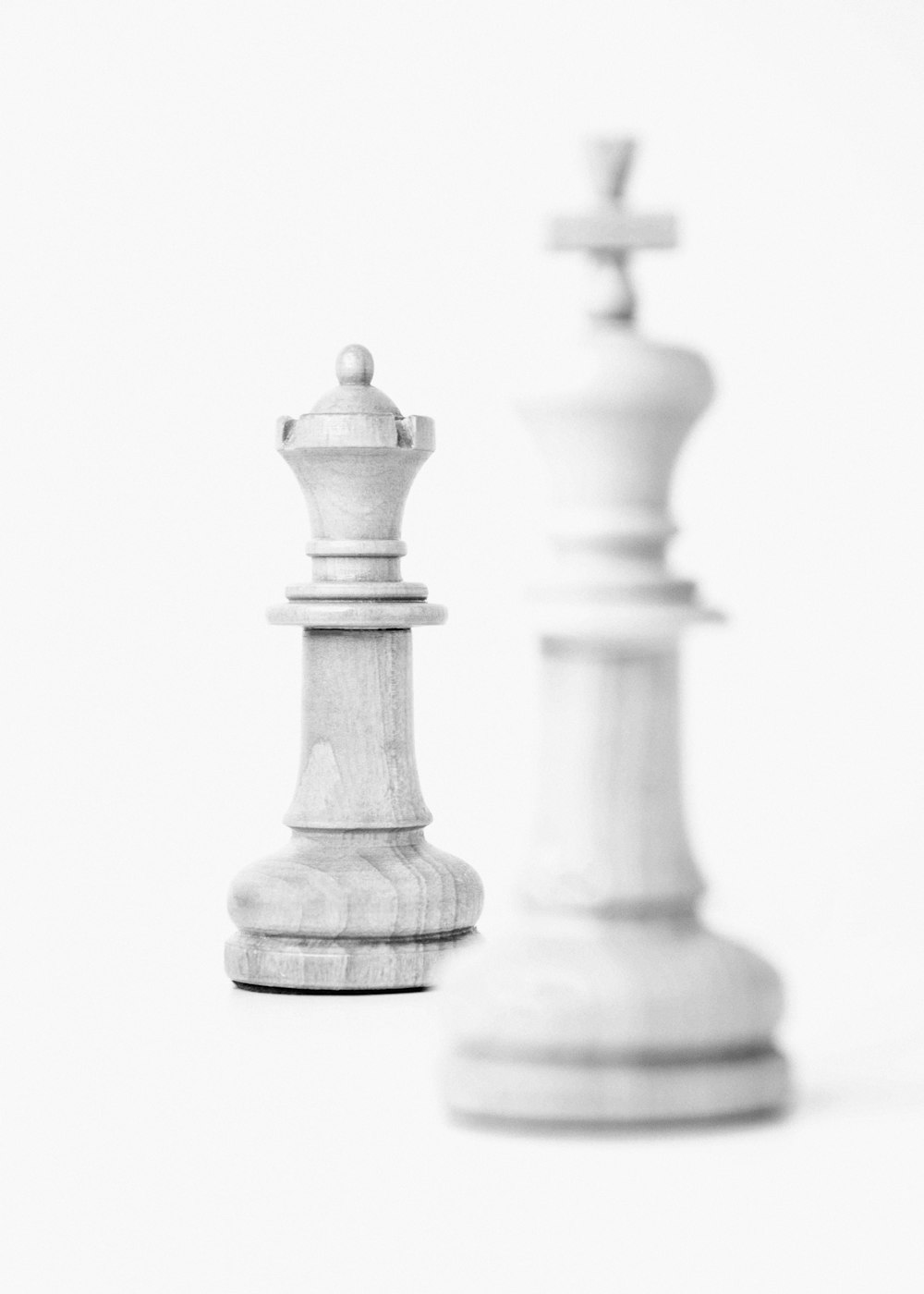 a black and white photo of two chess pieces