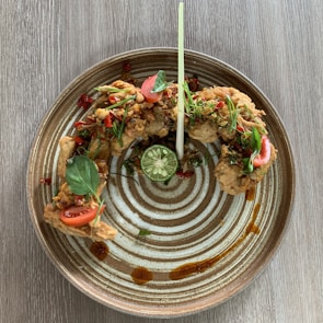 A beautifully arranged platter of chicken tikka leg pieces.