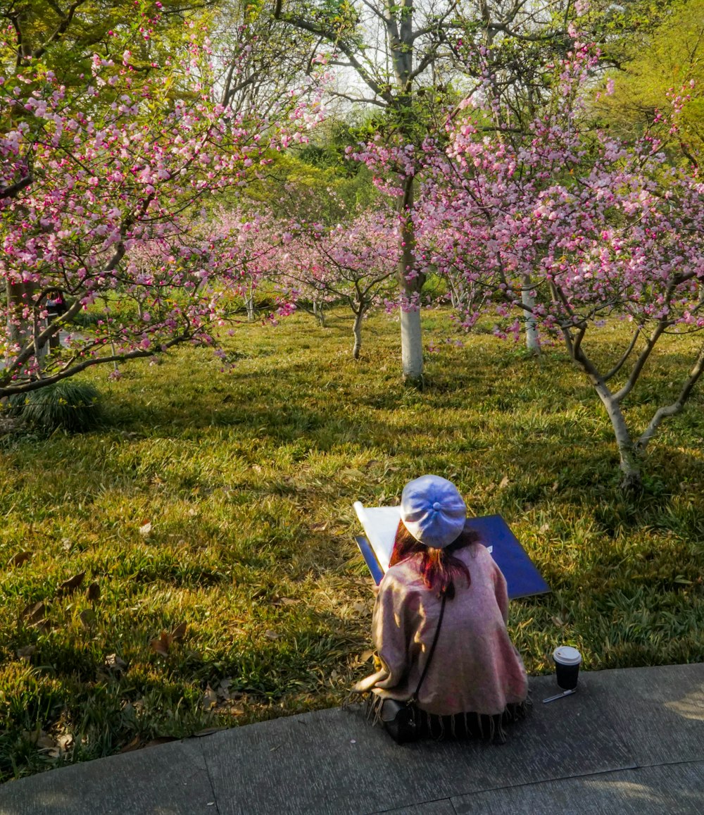 a woman sitting on a bench in a park