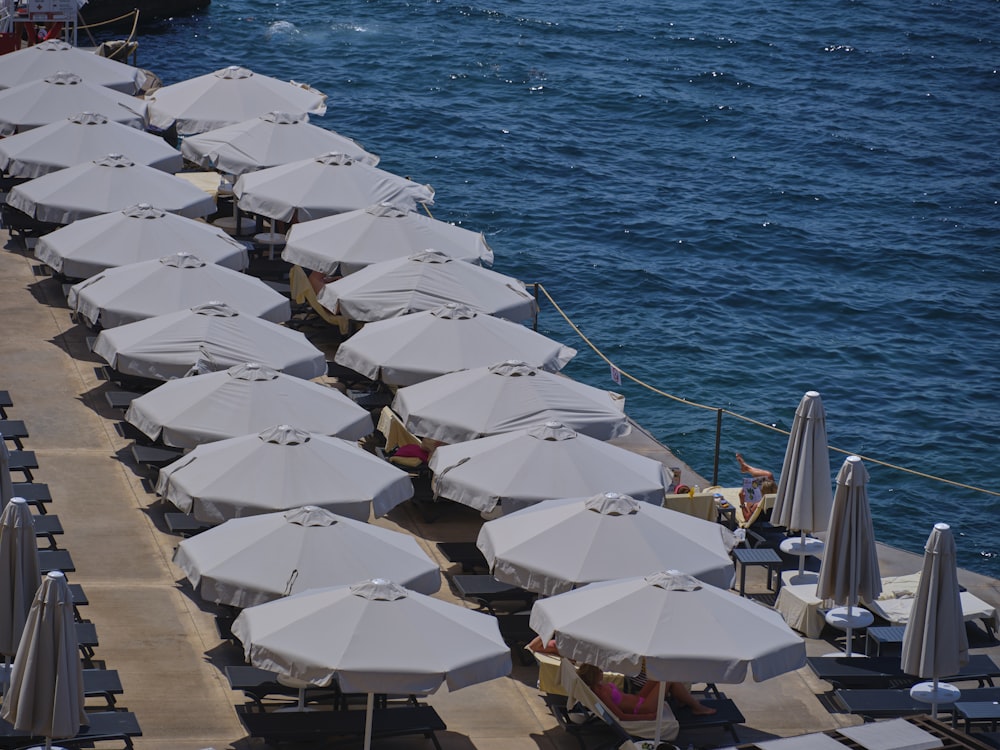 a bunch of umbrellas that are on a pier