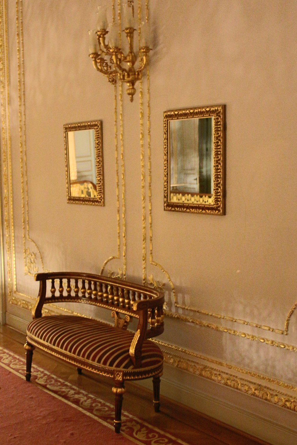 a bench in a room with a chandelier