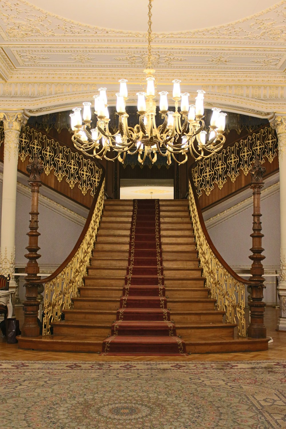 a grand staircase with a chandelier and chandelier