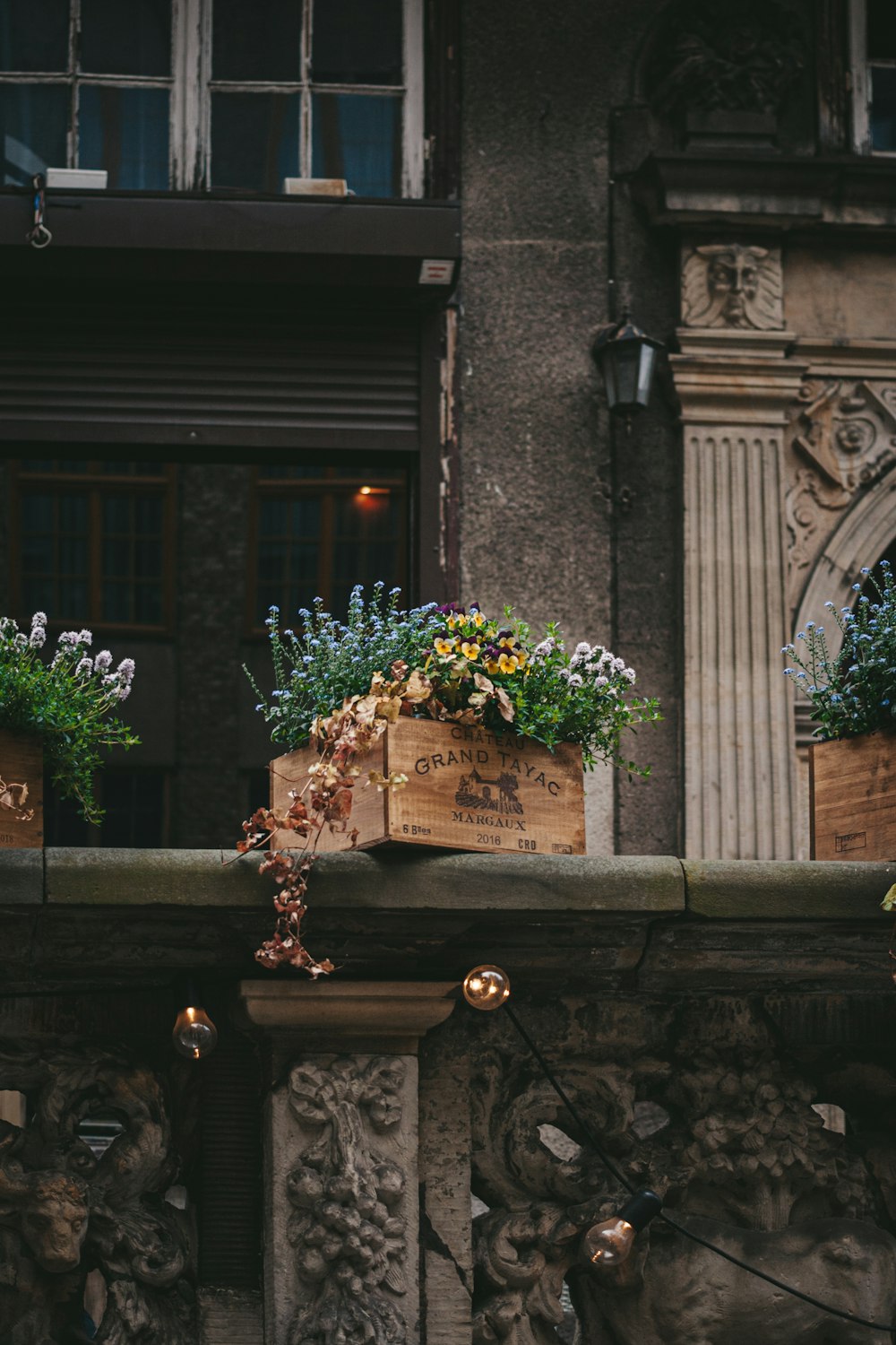 a couple of planters sitting on top of a stone wall