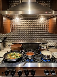 A sleek cooker with pots simmering, ready for a home-cooked meal.