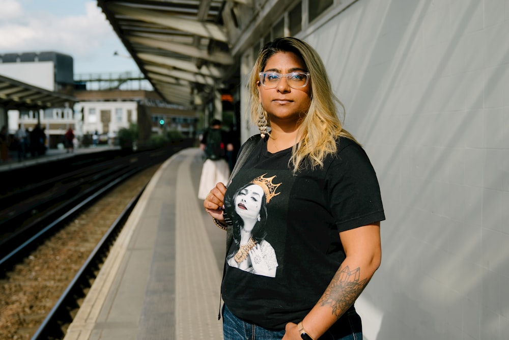 a woman standing in front of a train station