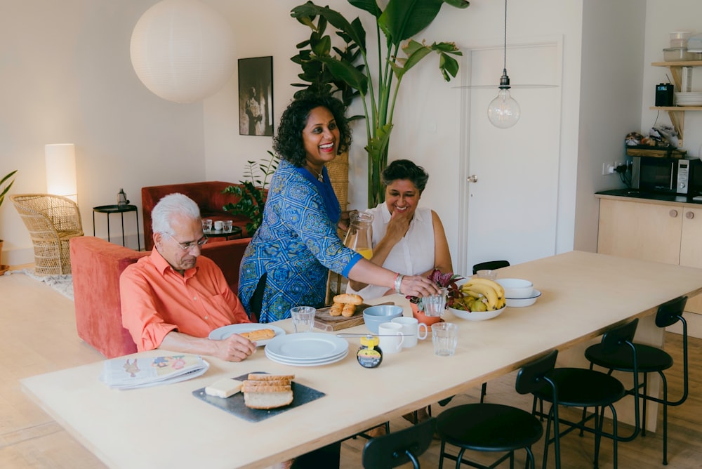 a group of people sitting around a table eating food