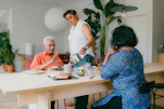 a group of people sitting around a table eating food