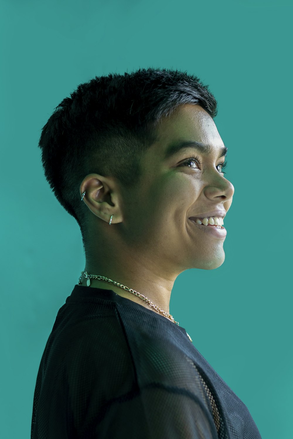 a woman with a short haircut smiling at the camera