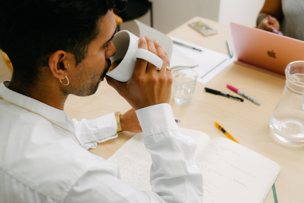 a man sitting at a table talking on a phone