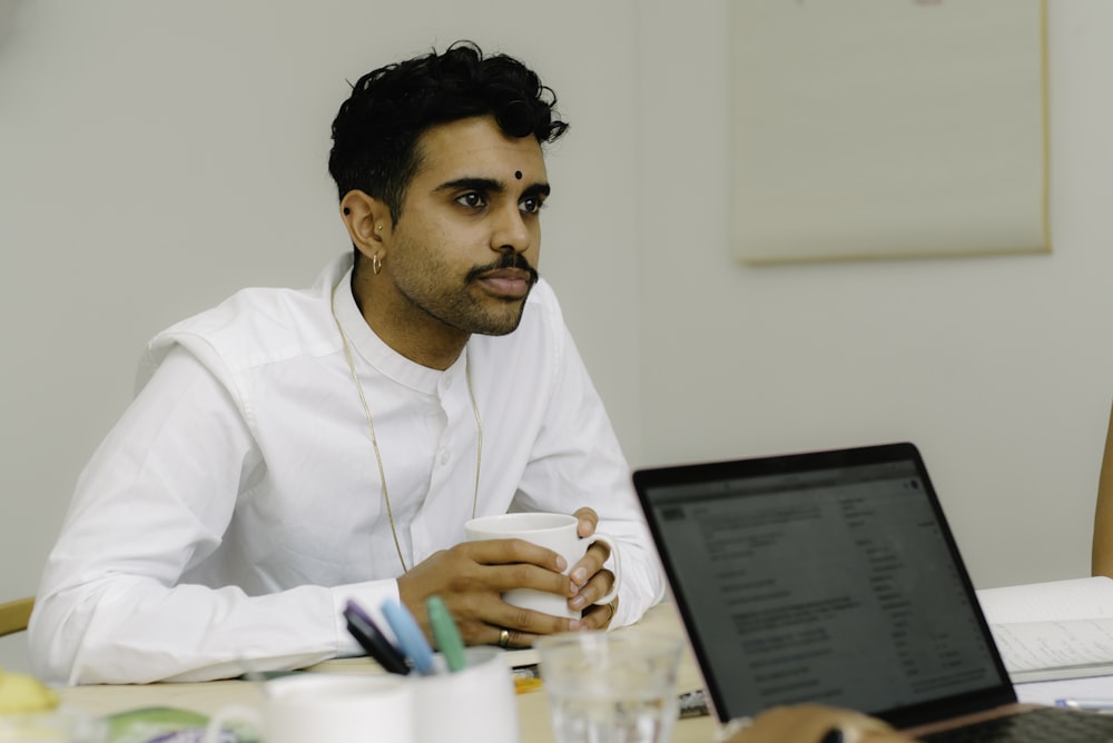 a man sitting in front of a laptop computer