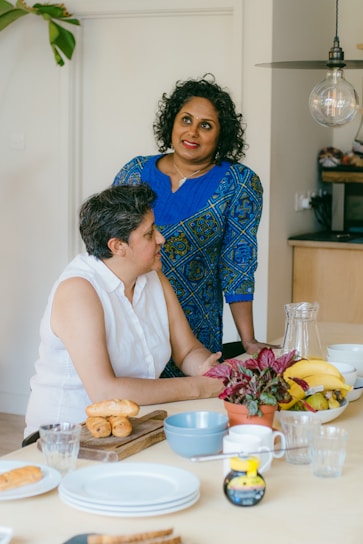 A friendly dietitian consulting with a client in a cozy, bright office filled with plants and nutrition charts.