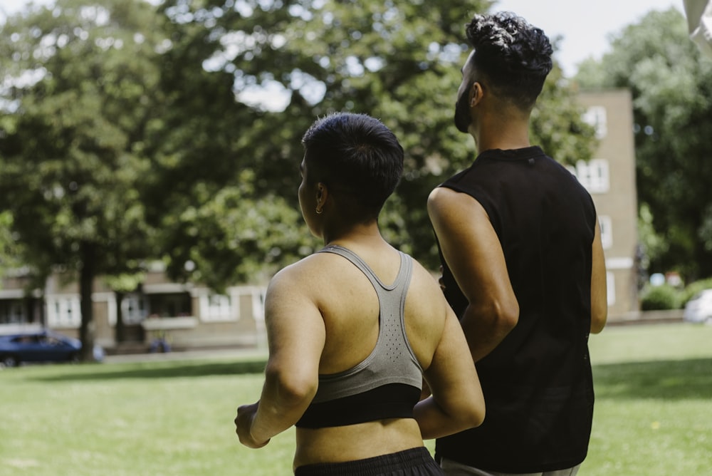 a couple of people that are standing in the grass