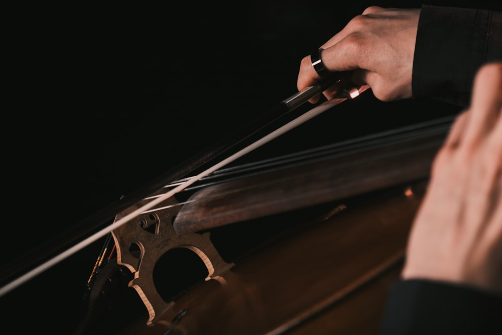 a close up of a person playing a violin