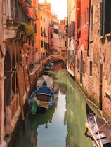 a canal with several boats in it next to buildings