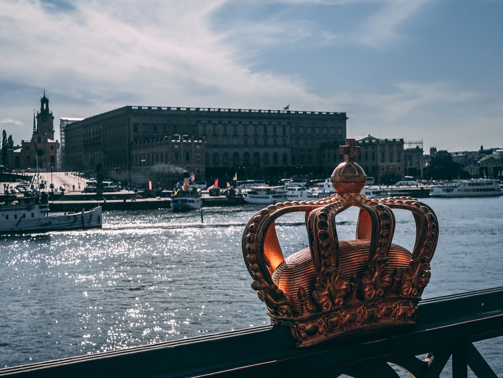 a crown sitting on top of a wooden rail