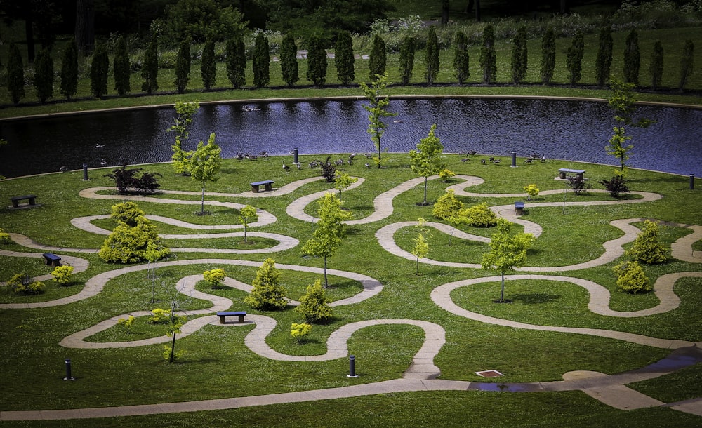 an aerial view of a park with a river and trees