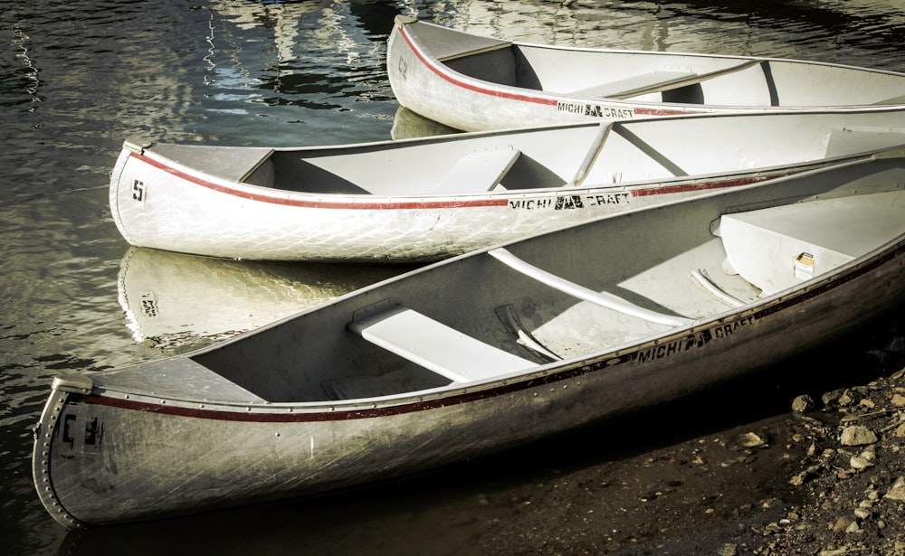a couple of canoes sitting on top of a body of water