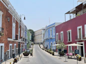 a street lined with colorful buildings and tables