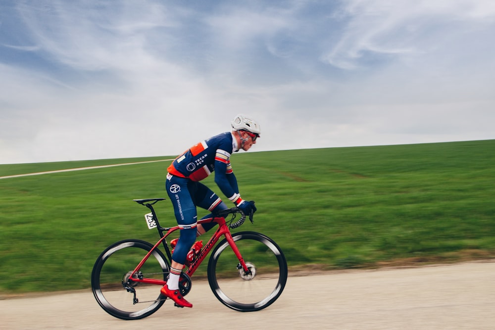 a man riding a bike down a dirt road