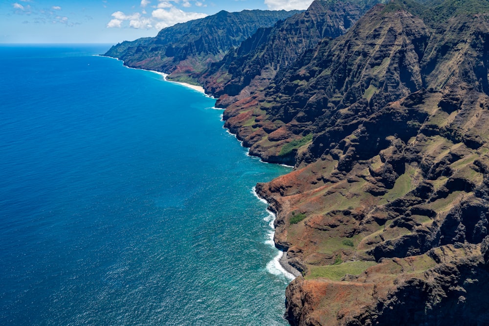 an aerial view of the ocean and mountains