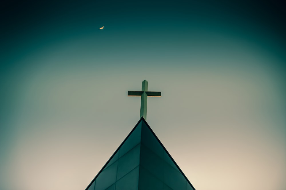 a church steeple with a cross on top of it