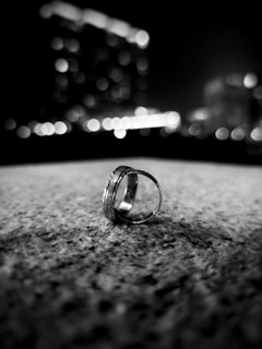 The MF Ring displayed on a hand with city lights blurred in the background, symbolizing global connectivity.