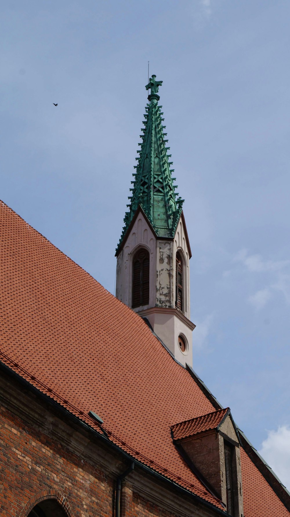 a church steeple with a green steeple on top