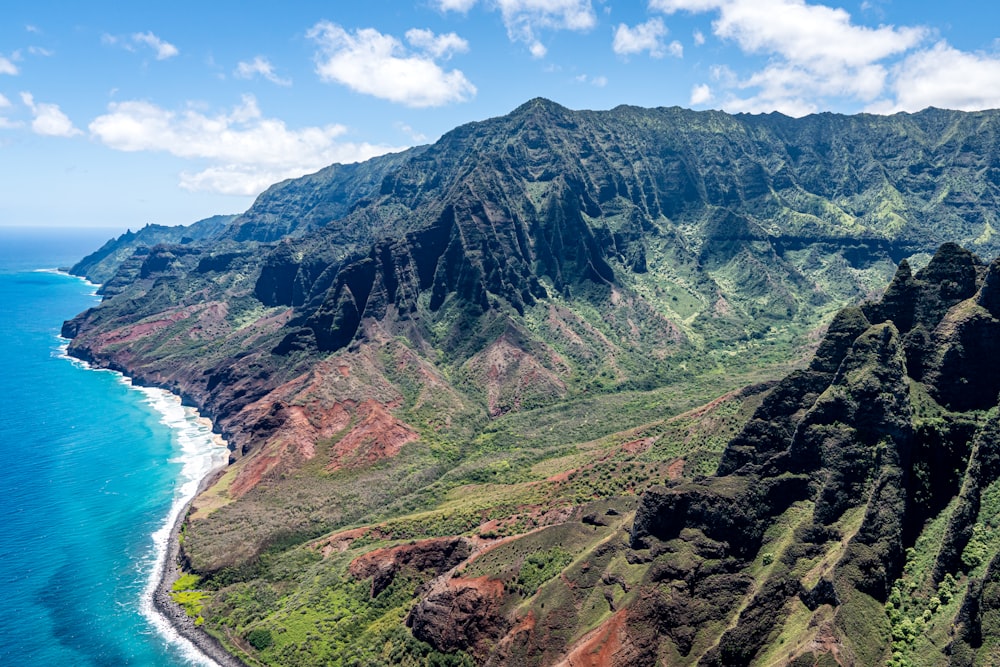 an aerial view of a lush green mountain side