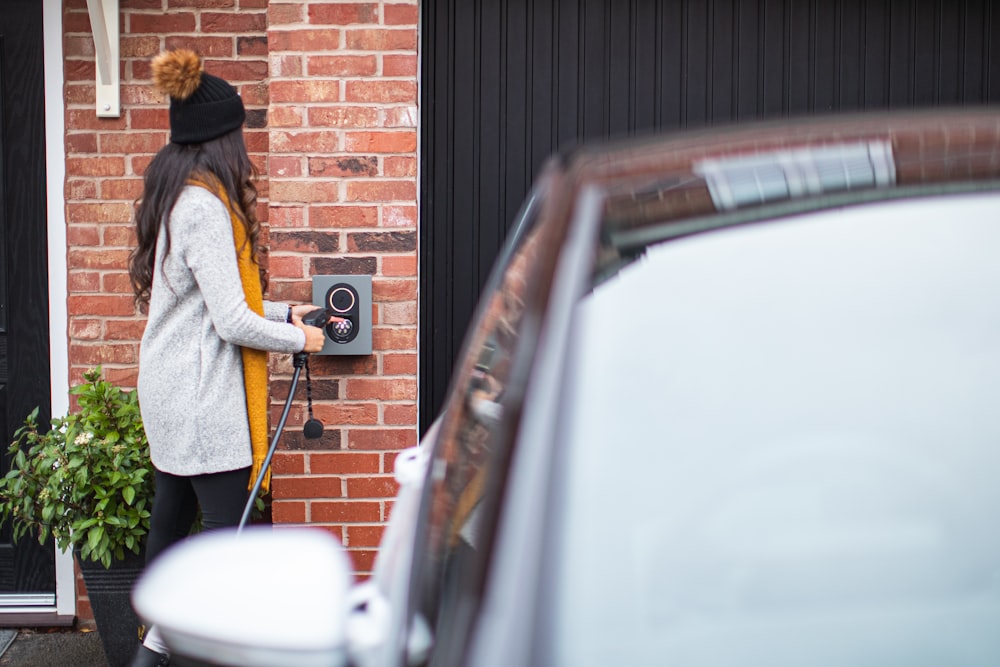 a woman opening a door with a cordless phone