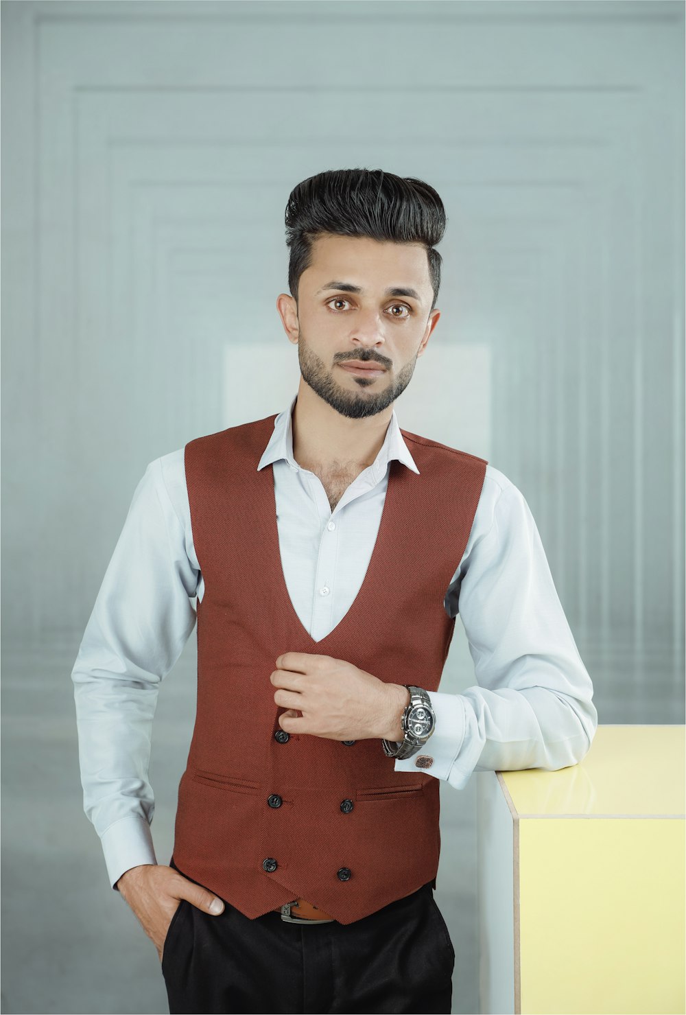 a man in a red vest and white shirt