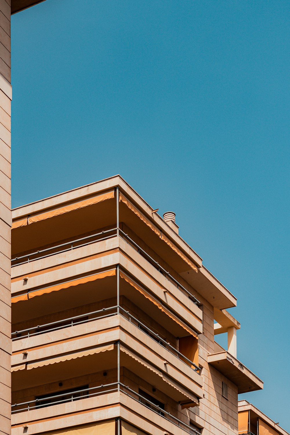 a tall building with balconies on top of it