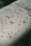 Close-up of pure water droplets on a sleek medical device surface.
