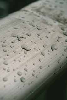 Close-up of crystal-clear water droplets on a sleek water filter surface