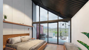 Luxurious bedroom with floor-to-ceiling windows framing the lush hillside scenery.