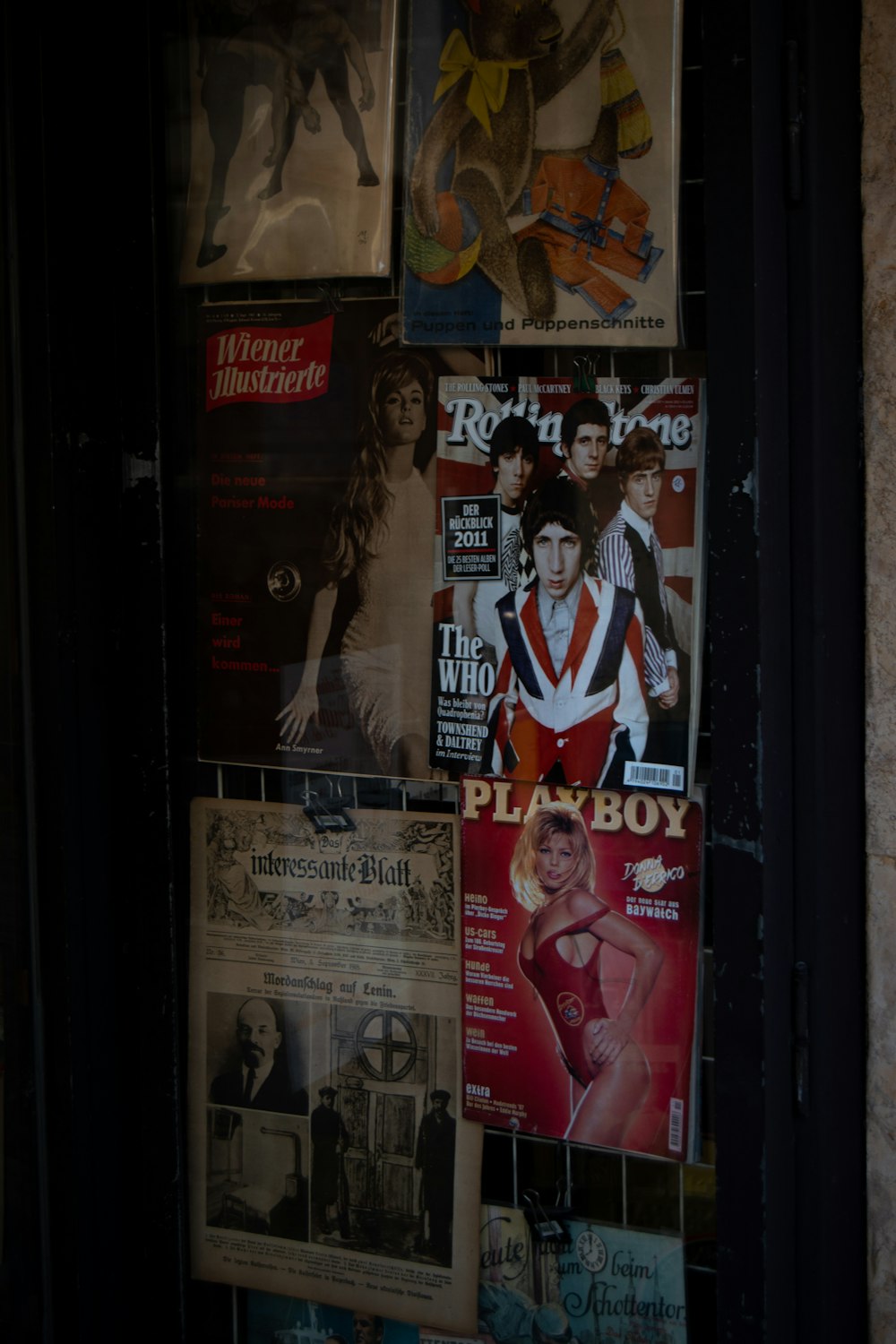 a bunch of magazines are hanging on a wall