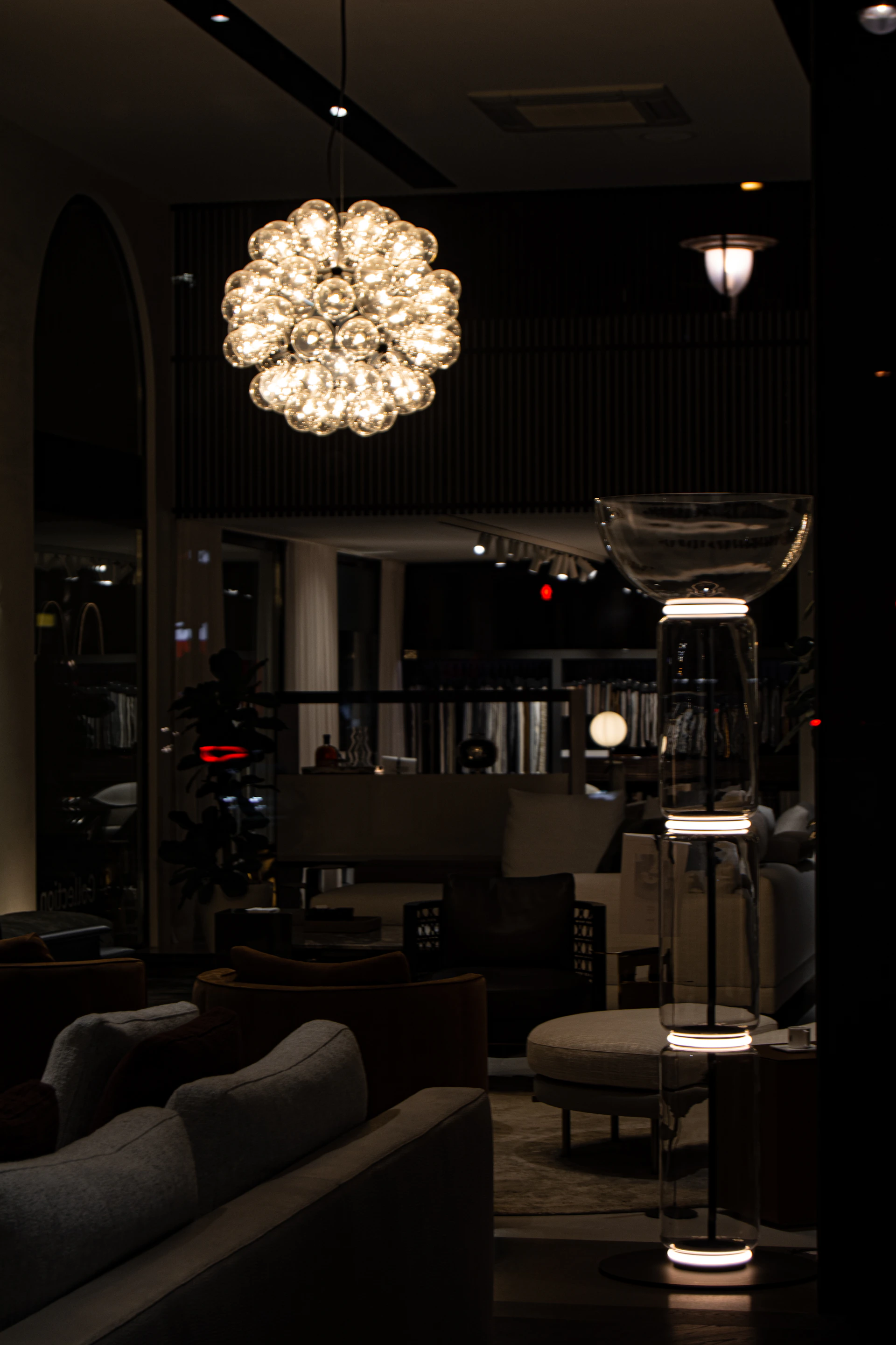 a living room filled with furniture and a chandelier