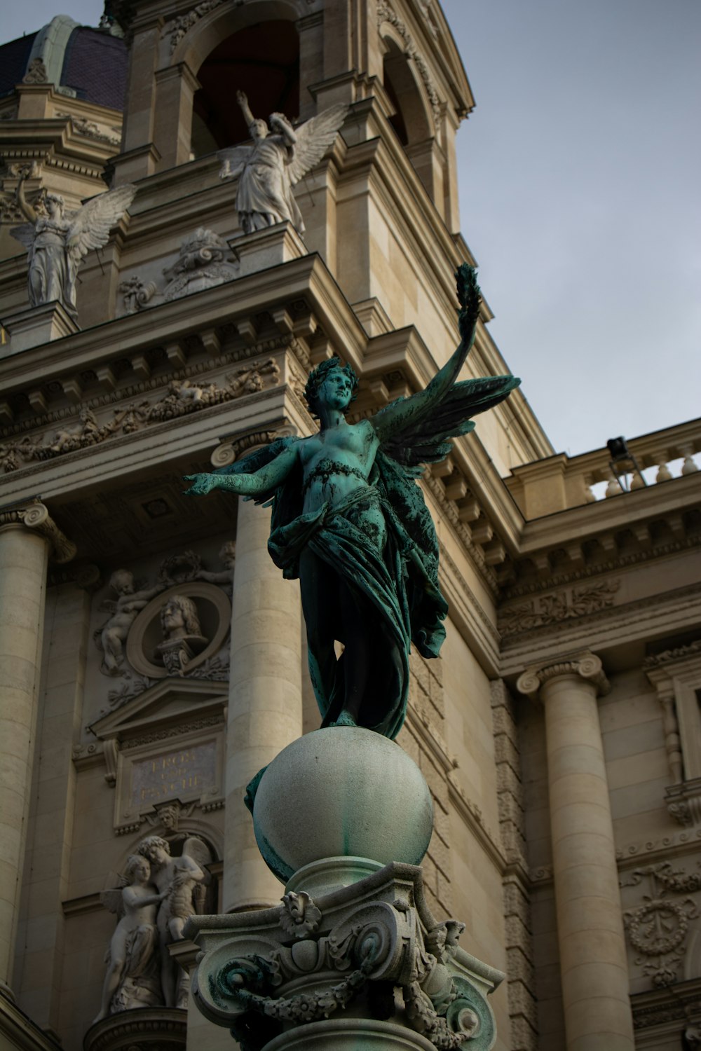a statue of a woman with wings on top of a building