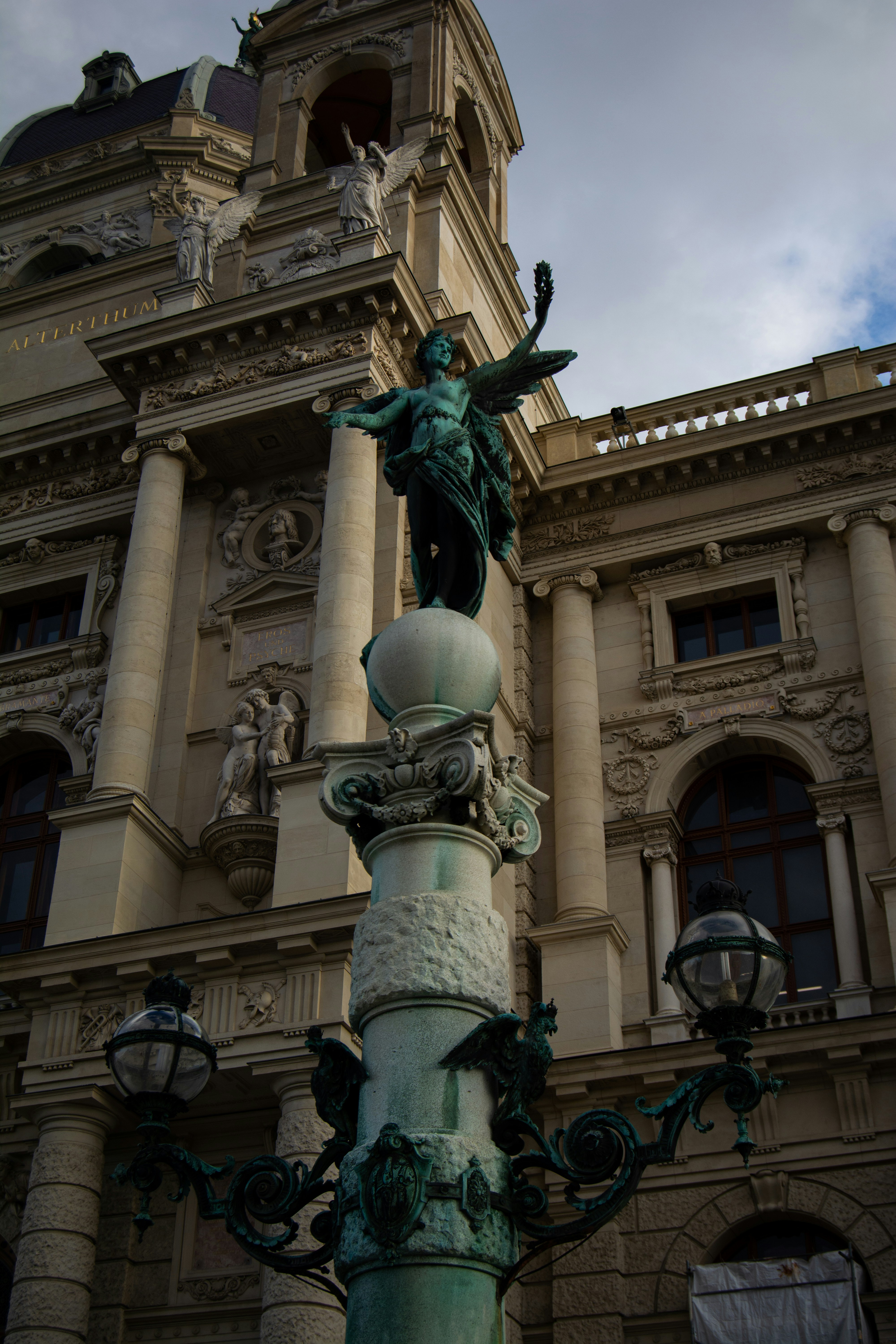 a tall building with a statue on top of it