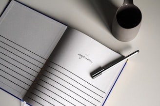 a notebook with a pen on top of it