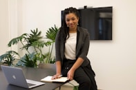 a woman sitting at a desk with a laptop