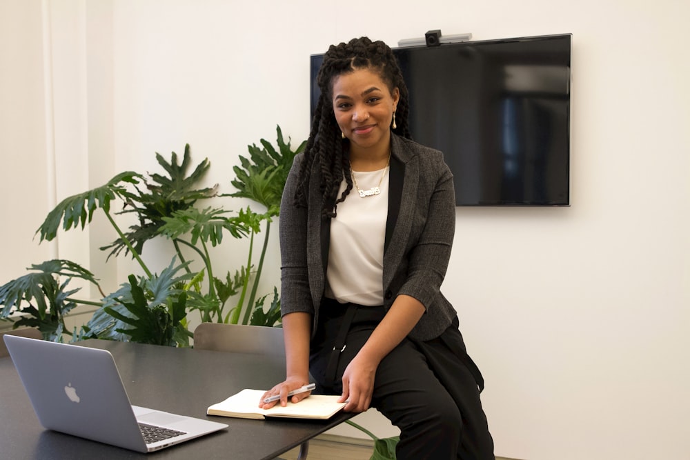 a woman sitting at a desk with a laptop