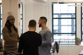 a group of men standing around each other in a room