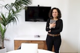 a woman standing in front of a flat screen tv