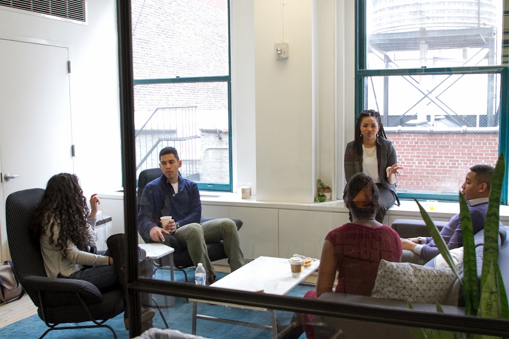 a group of people sitting around a living room