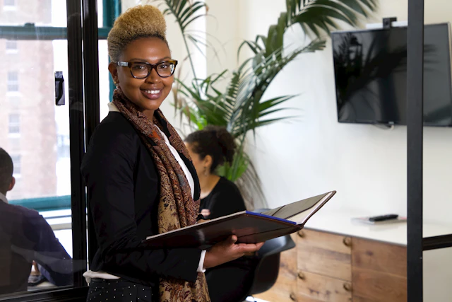 African executive reviewing documents in an office