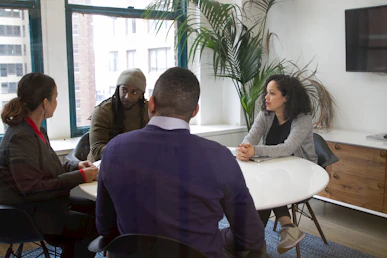 a group of people sitting around a table
