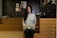 a woman standing in front of a laptop computer