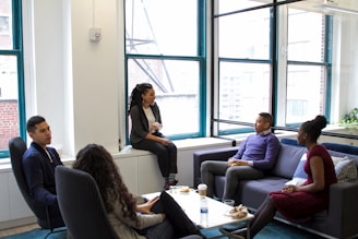 a group of people sitting around a living room